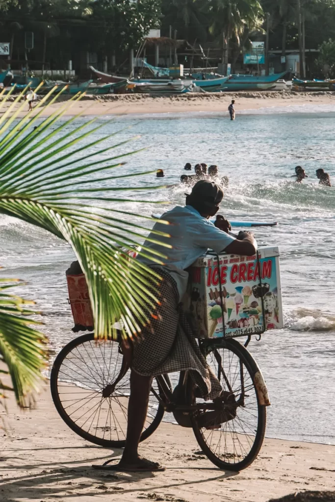 A local man sells ice cream from a push bike on Arugam Bay beach