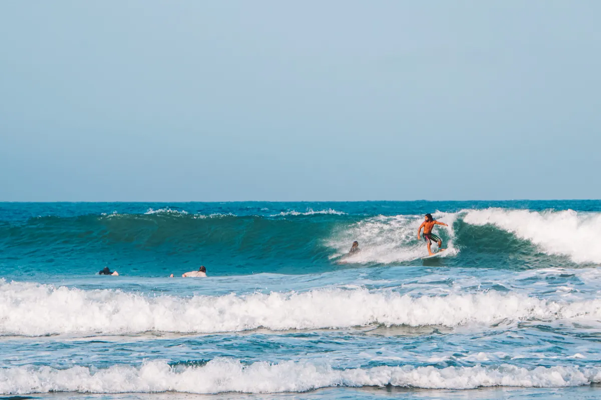 Surfer on a wave at Main Point, one of the top things to do in Arugam Bay