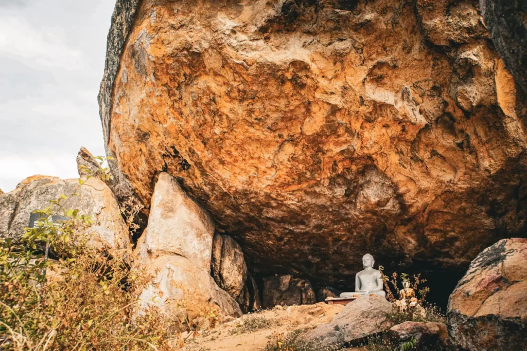 A buddha statue hidden under a giant boulder mid way up Elephant Rock