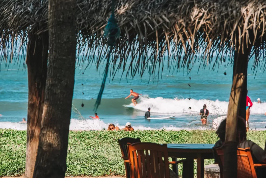 A surfer is on a wave on Peanut Farm beach