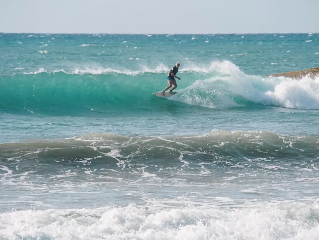 A surfer taking a high line on a nice right hand wave at Lighthouse Point