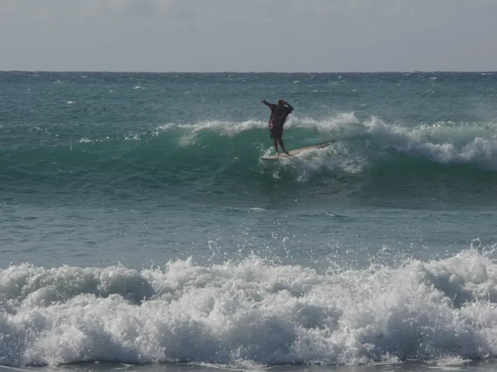 A longboard walking to the nose at Lighthouse surf spot Arugam Bay