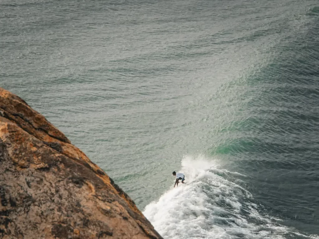 A local boy drops into a nice wave at Elephant Rock shot from the top