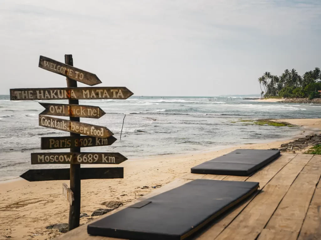 A sign with distances to world cities at Hakuna Matata in Ahangama