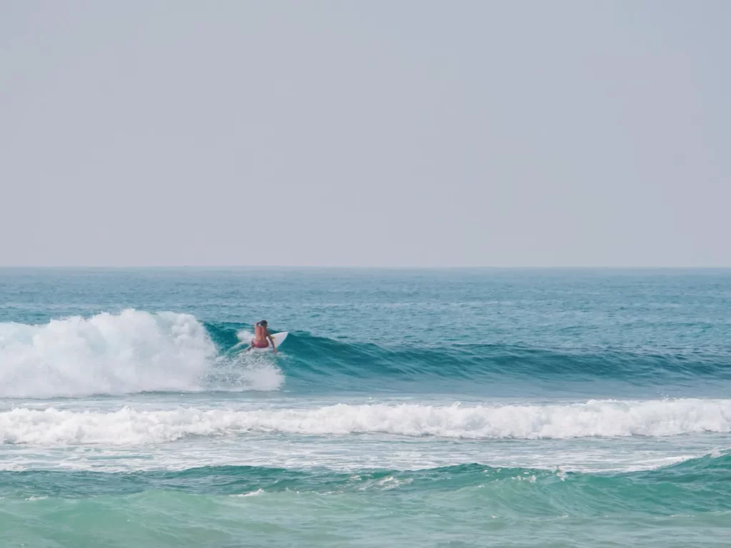 A man performs a cutback on a left hand wave at The Rock Kabalana