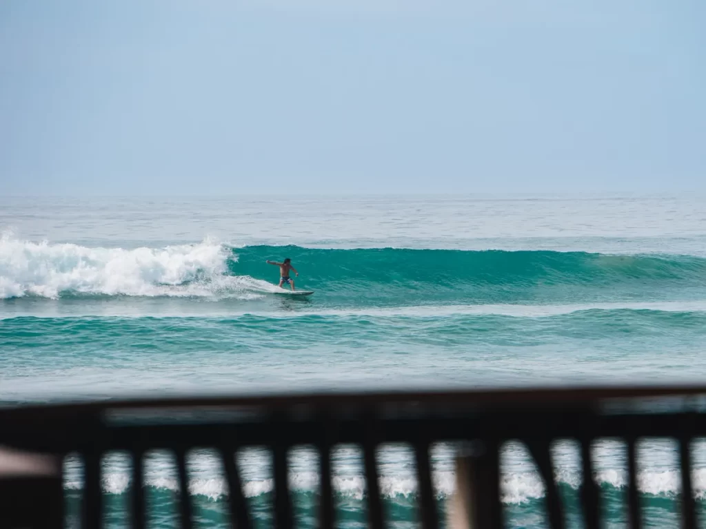 A surfer riding a wave at Stick Surf Spot, Ahangama