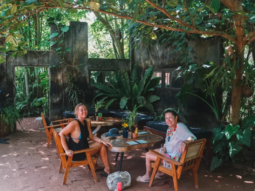 Two girls sitting in the old ruins of Trax restaurant