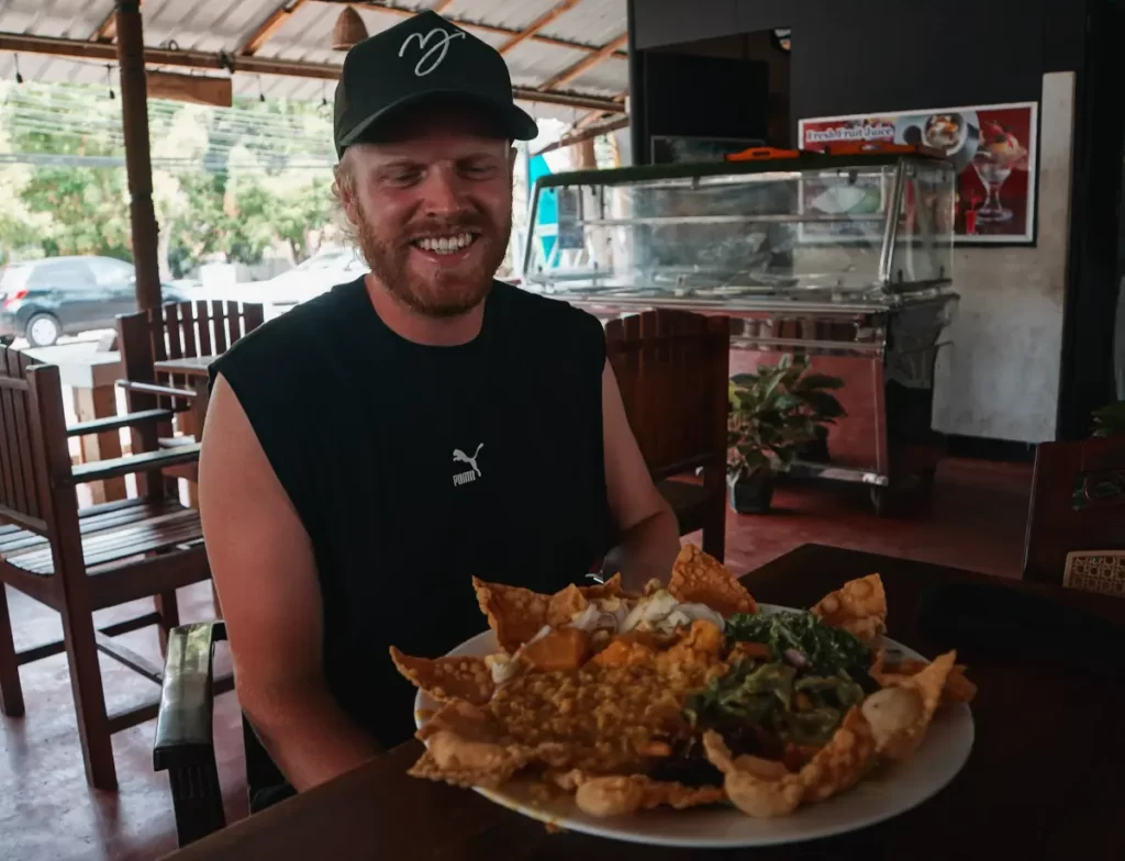 A man looks at his giant rice and curry plate at Mama's Arugam Bay, enough food to feed one of the local Elephants. Mmmmmm.