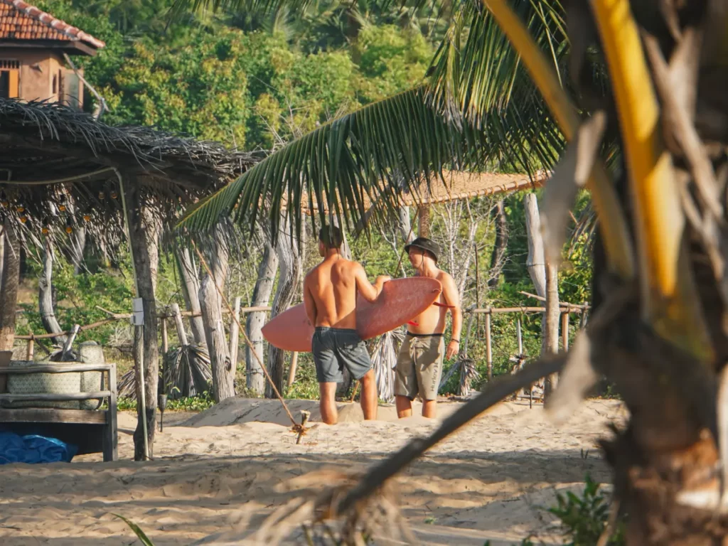 Two surfers chatting at sunset at Hilltop Cabanas