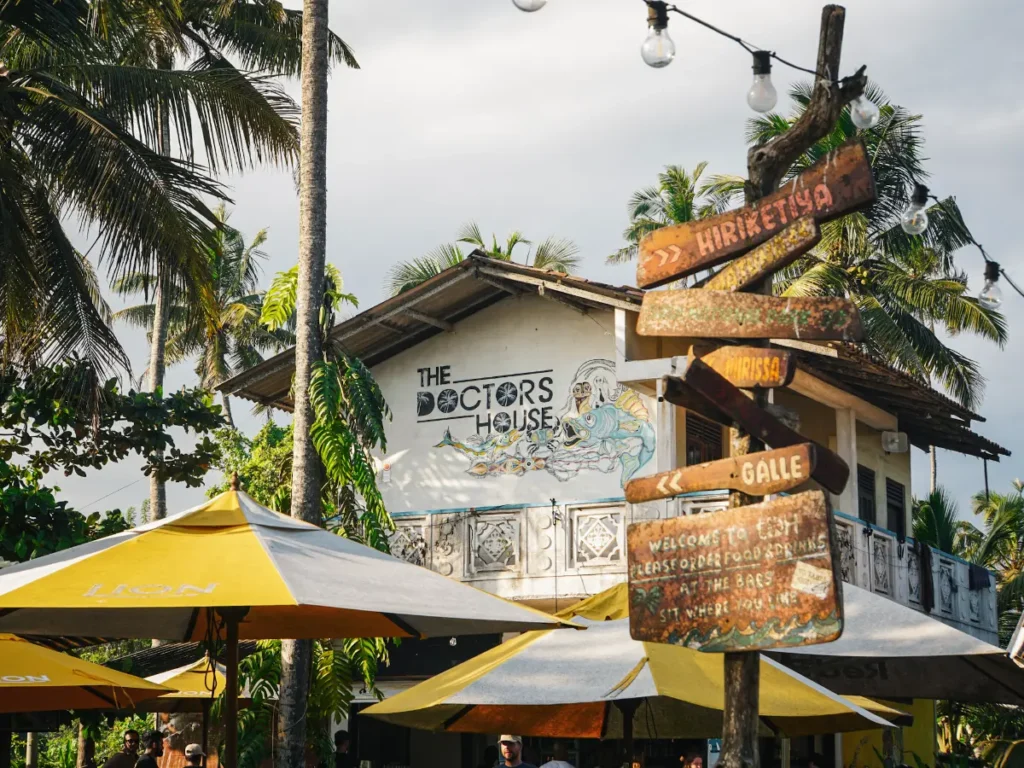 The Doctors House painting and sign at sunset in Madiha