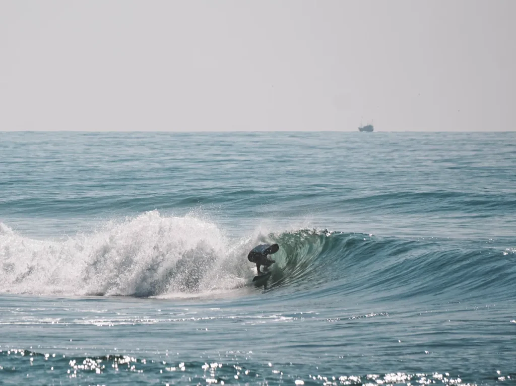 A man getting barrelled at the Madiha Right Surf Point