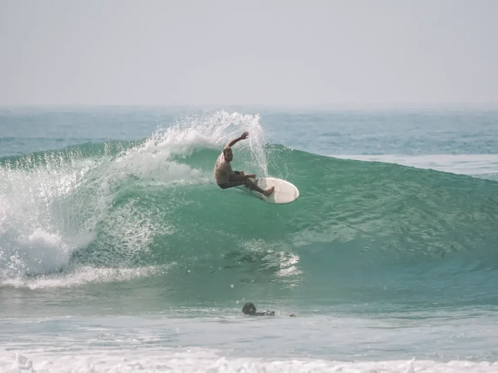 A surfer performs a big cutback on the Madiha Right surf spot