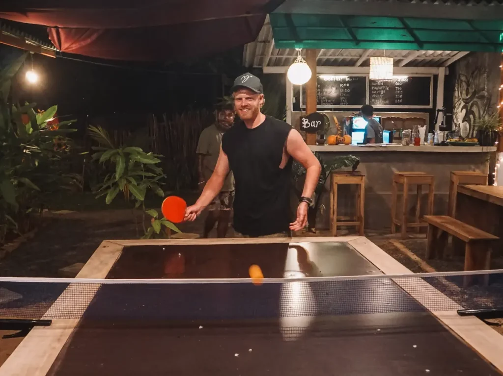 A man plays ping pong at Sand Bank in Madiha