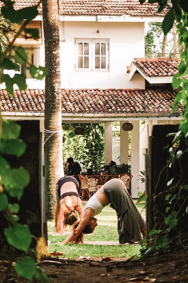 Two people in a yoga session at the Surf Lodge in Madiha