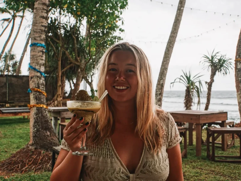 A girl drinks espresso martinis at Swell Shacks, a great place to stay in Madiha