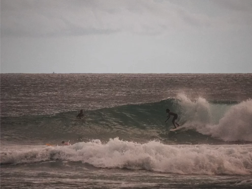 A surfer takes a fast right hand wave at The Rock Kabalana