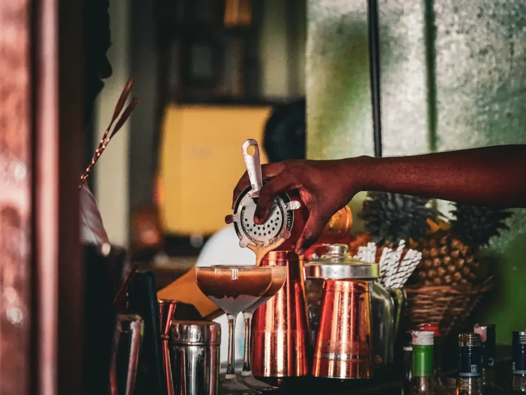 A man making two espresso martinis at Hotel de Uncles