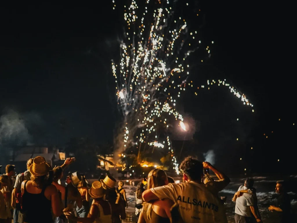 A group of party people watch fireworks on Ahangama Beach