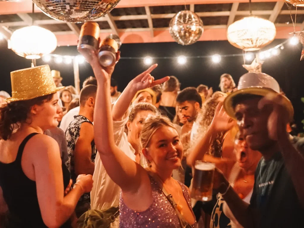 A girl holding beers at a party in Hotel de Uncles in Ahangama