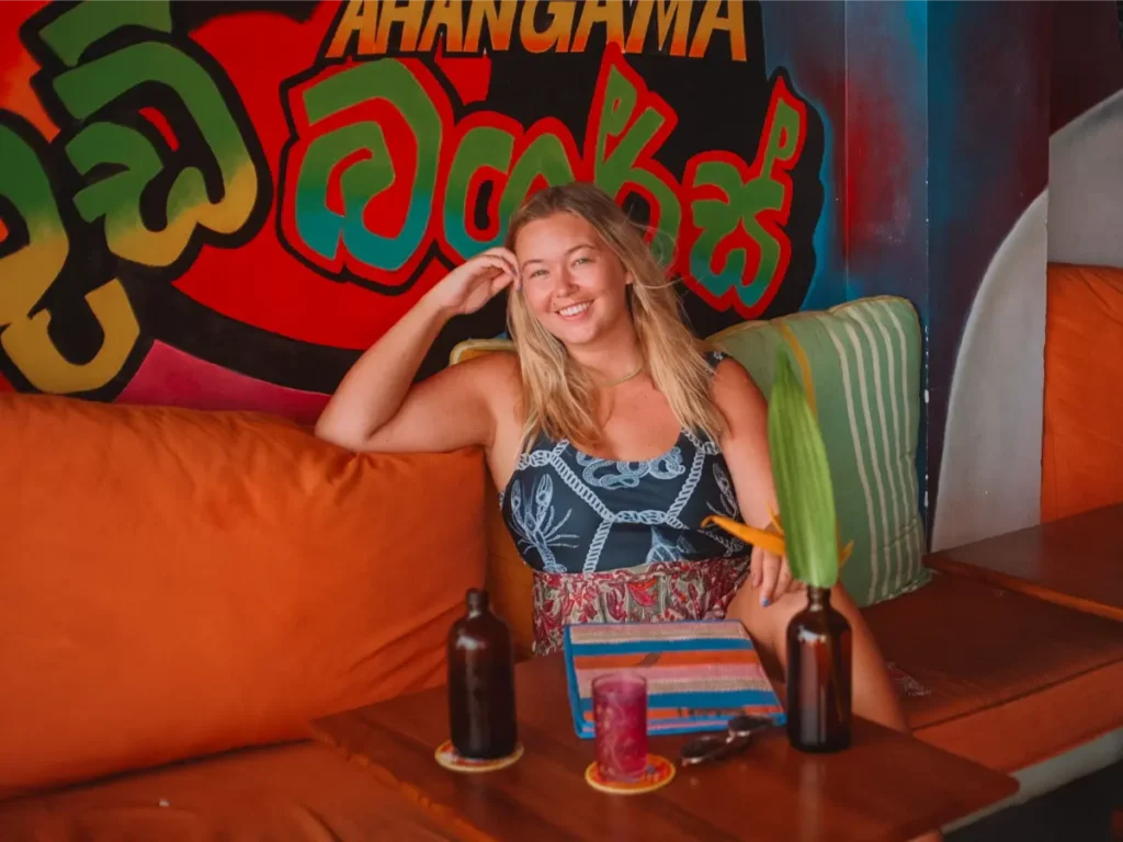 A girl sitting and smiling in Hotel de Uncles restaurant