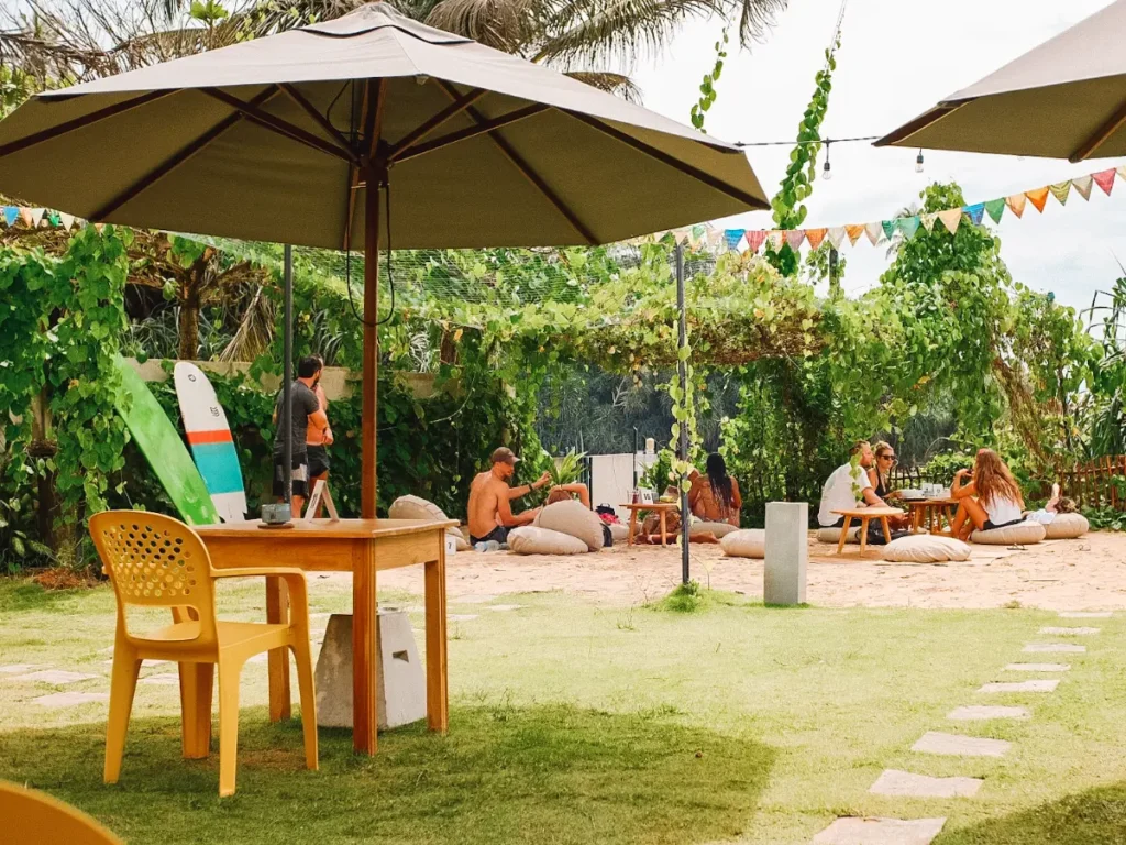 People sit on beanbags and in the shade at Kaffi and Little Bang Kitchen in Ahangama