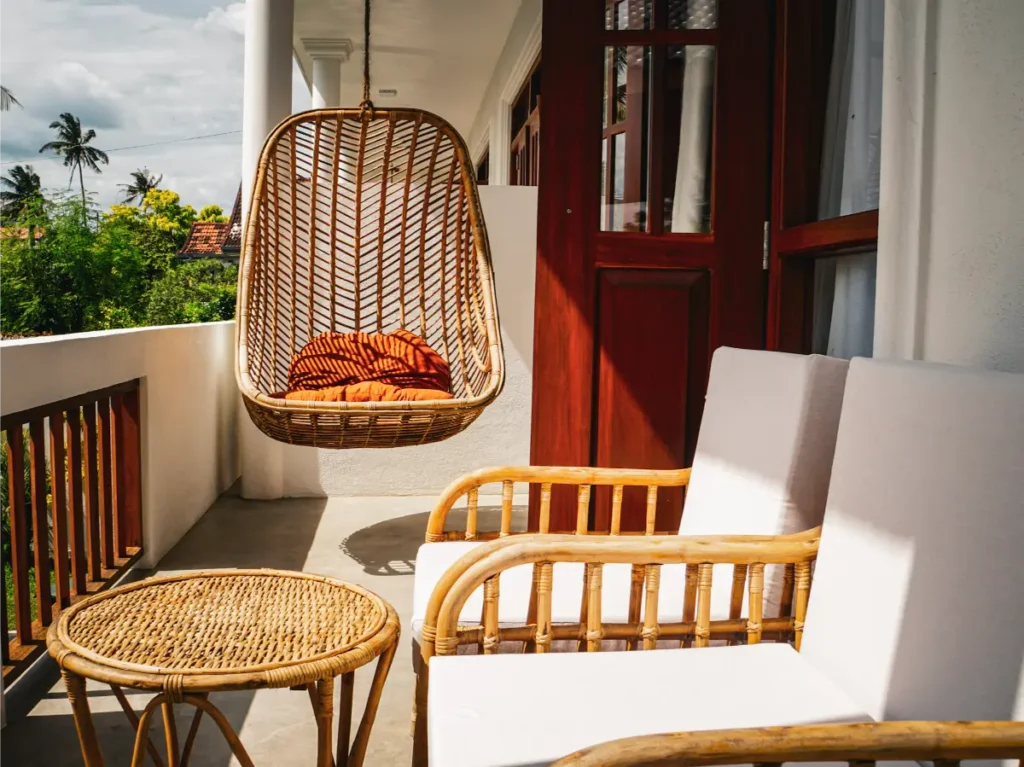 A hanging swinging chair on the balcony of Ohana Surf House in Ahangama