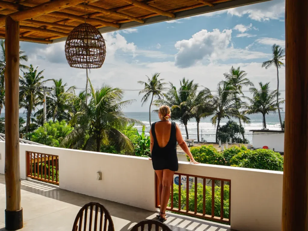 A girl standing on Ohana rooftop watching the waves