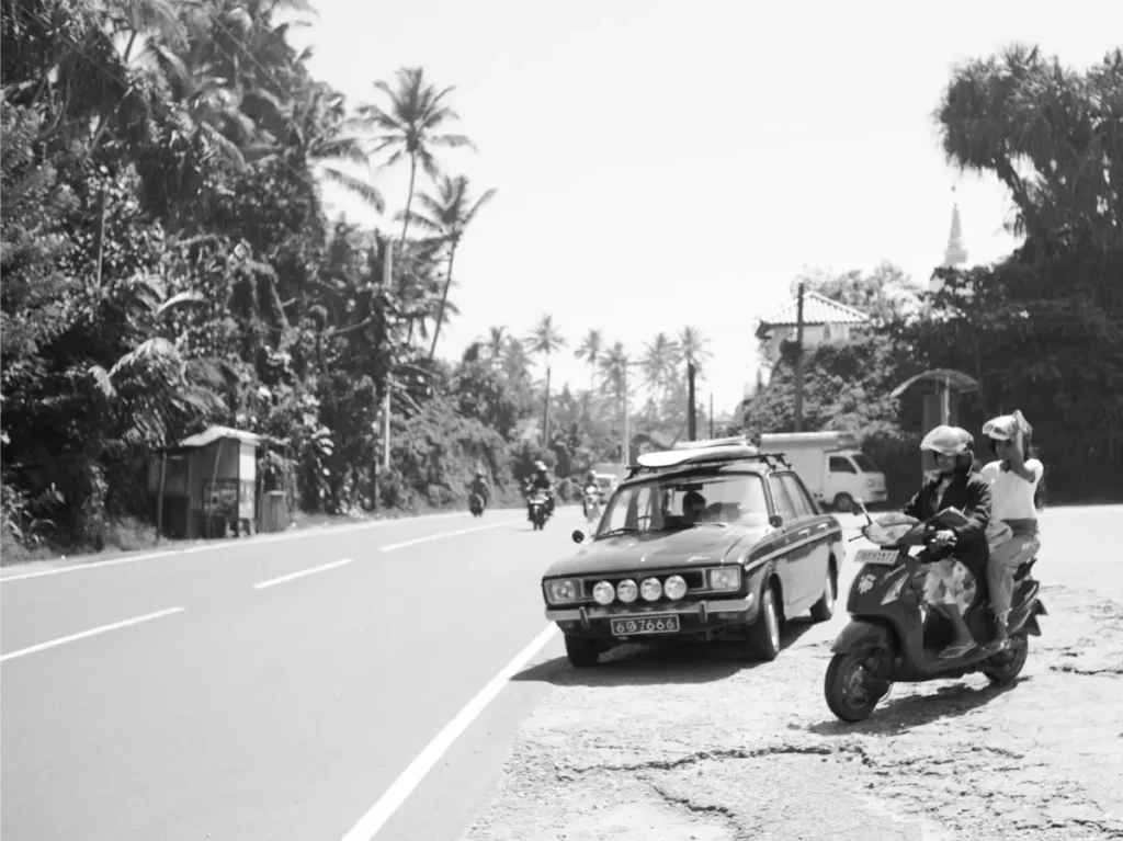 A classic car transporting surfboards in Ahangama