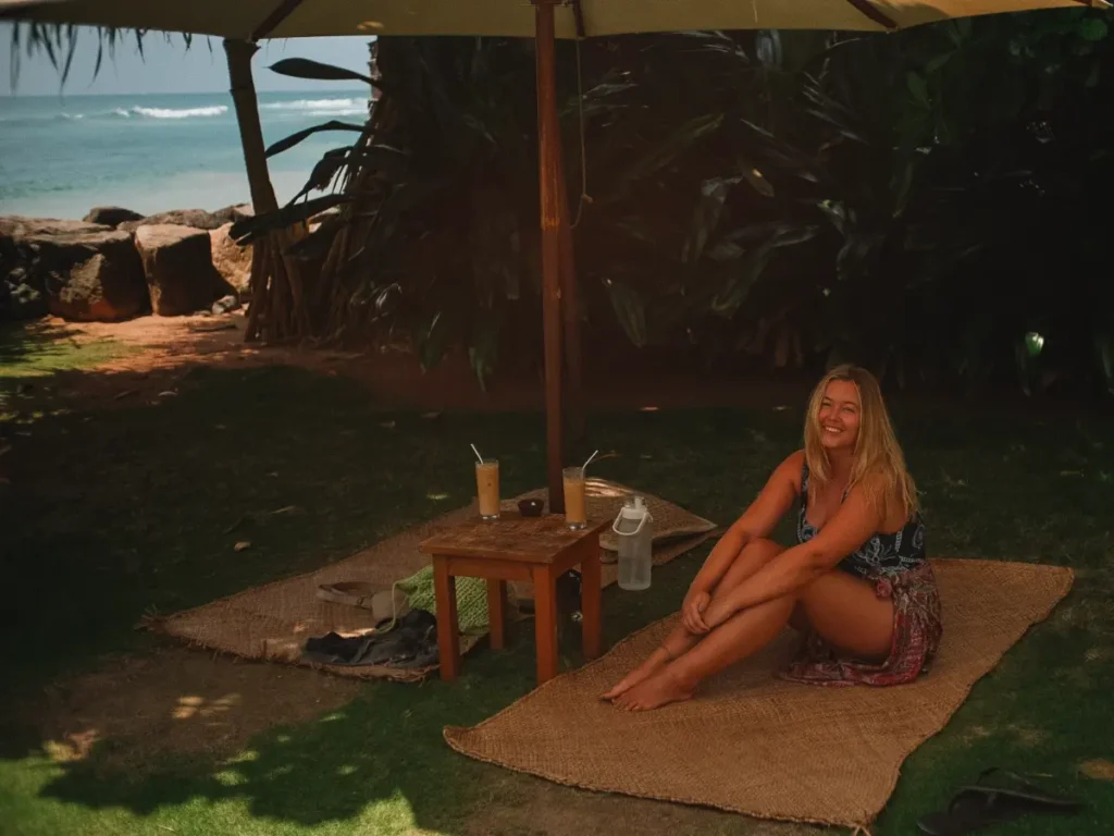 A girl sitting in Dreamsea Surf Camps garden, one of the best places to stay in Ahangama