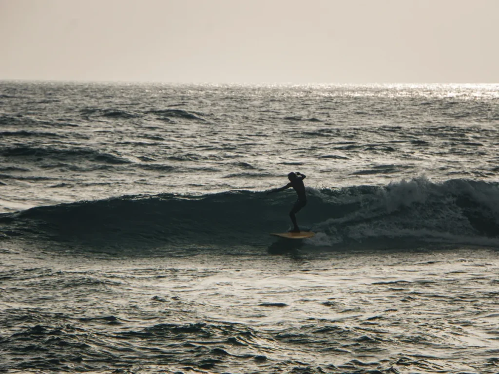 A longboarder riding Dreamsea Left in Ahangama