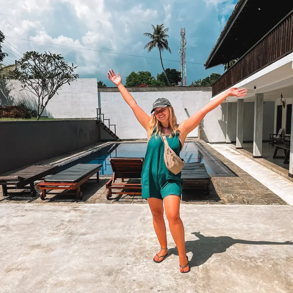 A girl standing in front of Eco Villa pool, one of the best places to stay in Ahangama