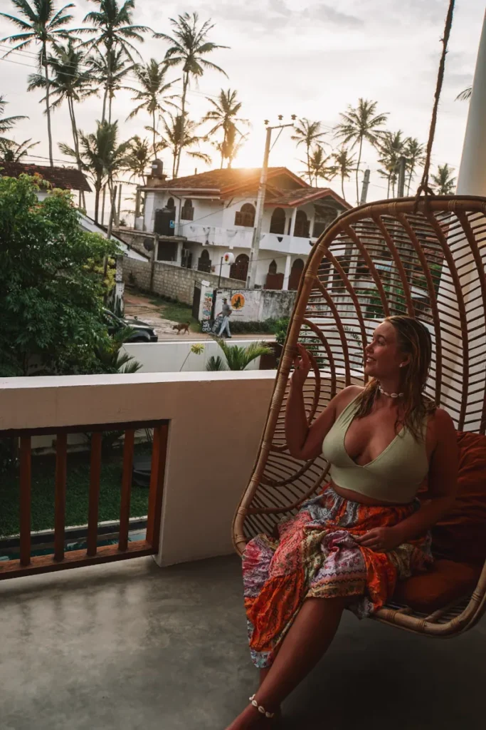 A girl sitting on the swinging chairs at Ohana Surf House