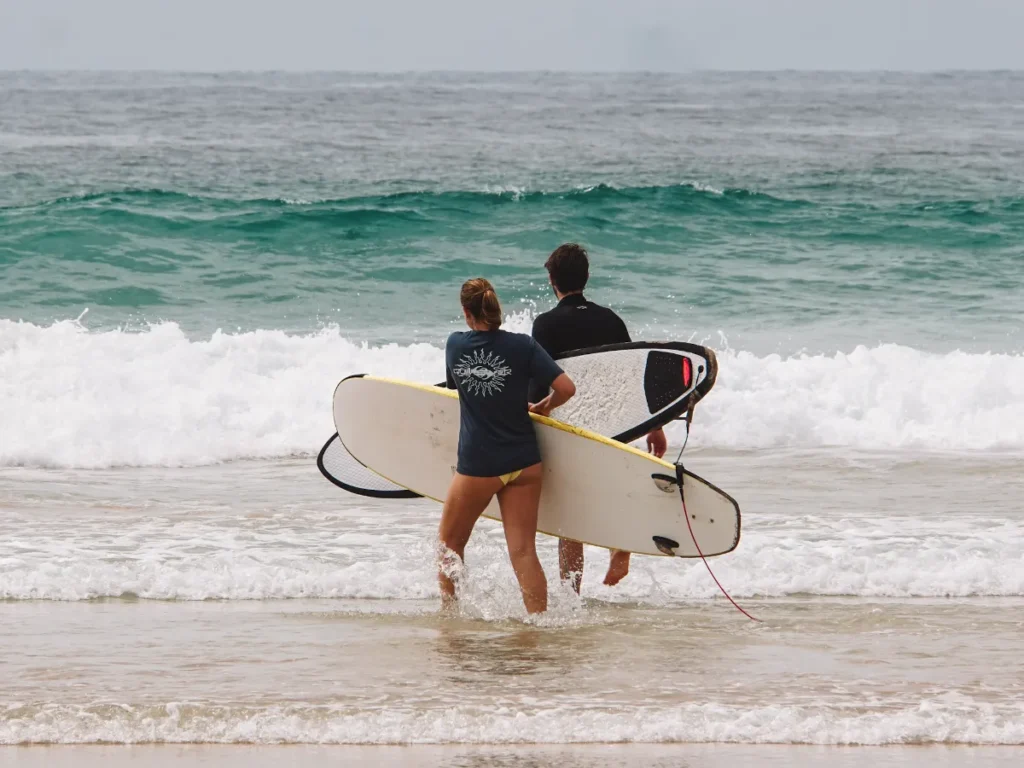 Two beginners going for a lesson at Kabalana Beach Break