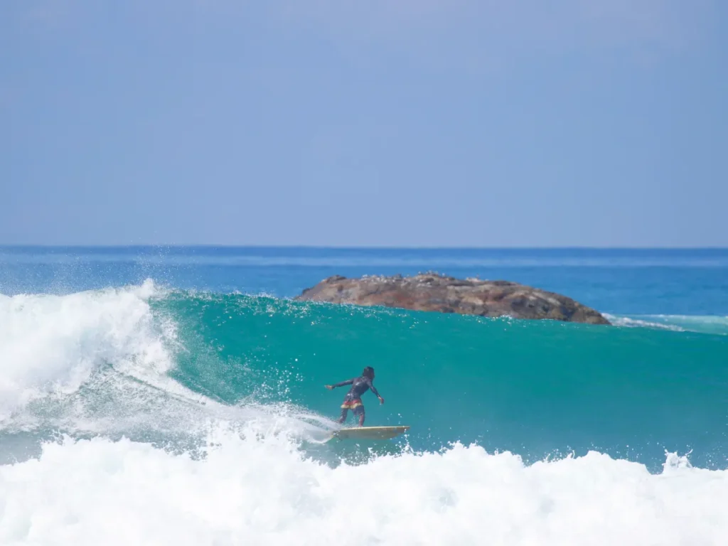 A local surfer hitting a big wave at The Rock