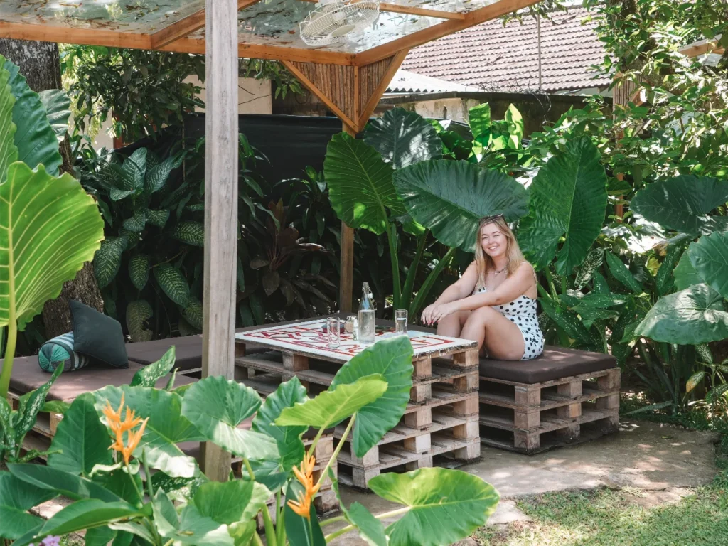 A girl sits between Colocasia Leaves at Komorebi, a top restaurant in Madiha