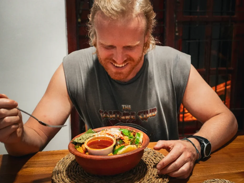 A man eats a Biriyani takeaway in Madiha
