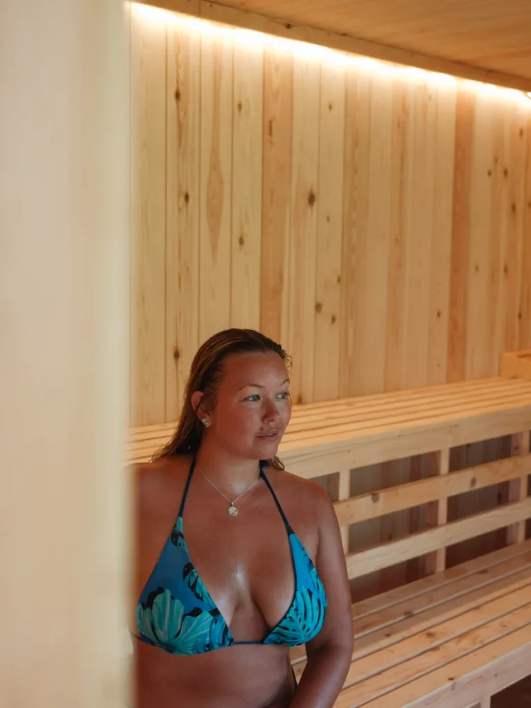 A girl sits in the sauna at Ember & Ice located at Wild Ahangama