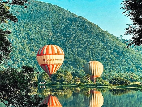 Two balloon prepare to take at a lake near Sigiriya