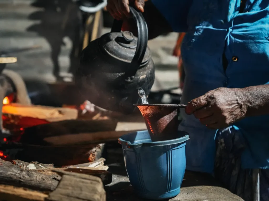 A local lady poors boiling water at a cooking class in Sigiriya