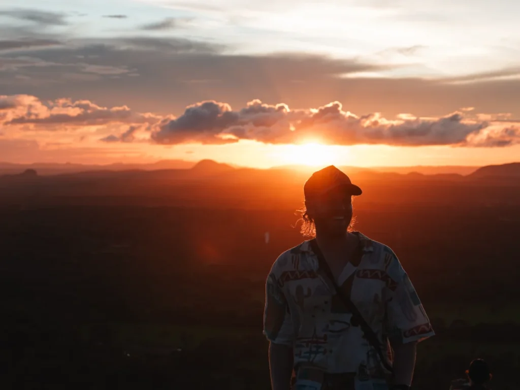 A silhouette of a man standing in front of the sunset at Sigiriya
