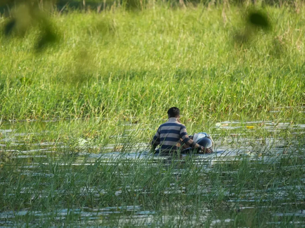 A local man fishing on a rubber ring in Sigiriya