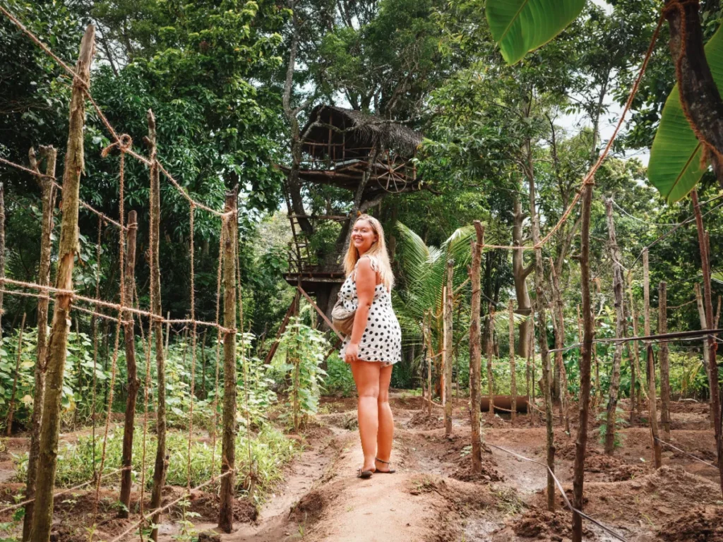 A girl walking through a farm on a village tour in Sigiriya
