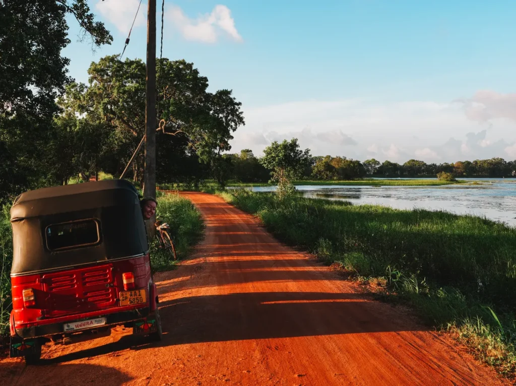 A girl driving a Tuk Tuk on the quiet dirt roads in Sigiriya