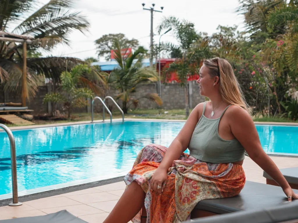 A girl sits by the pool at Paddyway Resort, a top place to stay in Arugam Bay