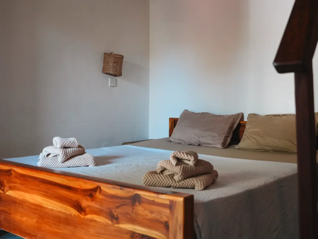 Fresh towels on a freshly made bed at Pompon, a top budget hotel in Arugam Bay