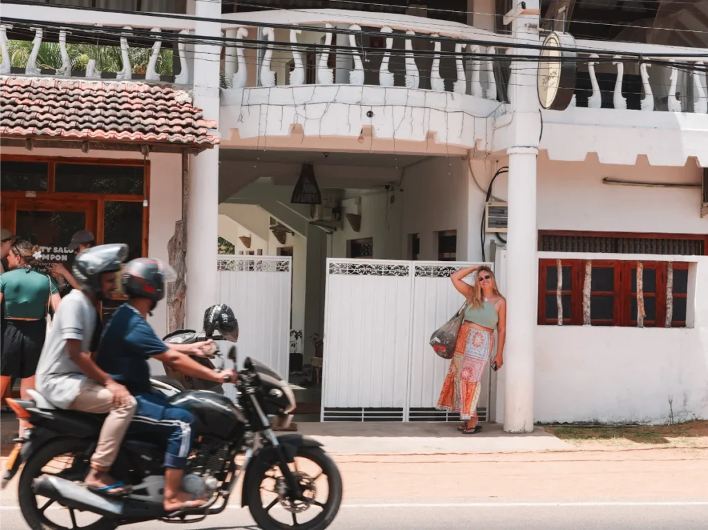 A girl stands outside the entrance at Pompon, a top hotel in Arugam Bay