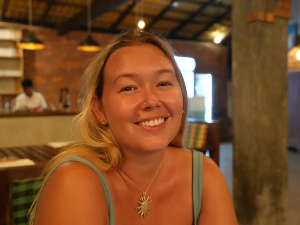 A girl smiles in the restaurant at Rupa's, a top budget hotel in Arugam Bay