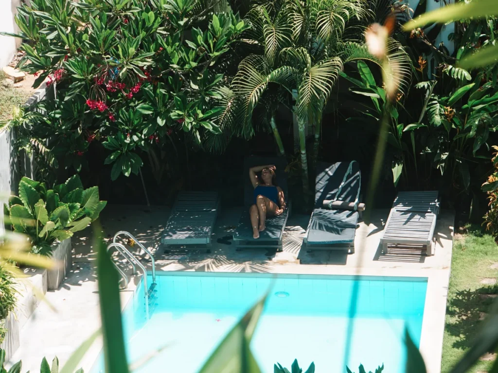 A girl lies by the pool at Surf Gangs in Arugam Bay