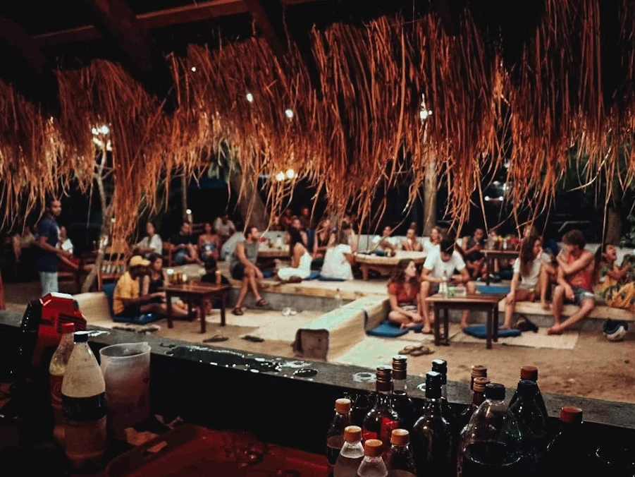 A group of travellers have drinks in the social area at Waypoint, a top hostel in Arugam Bay