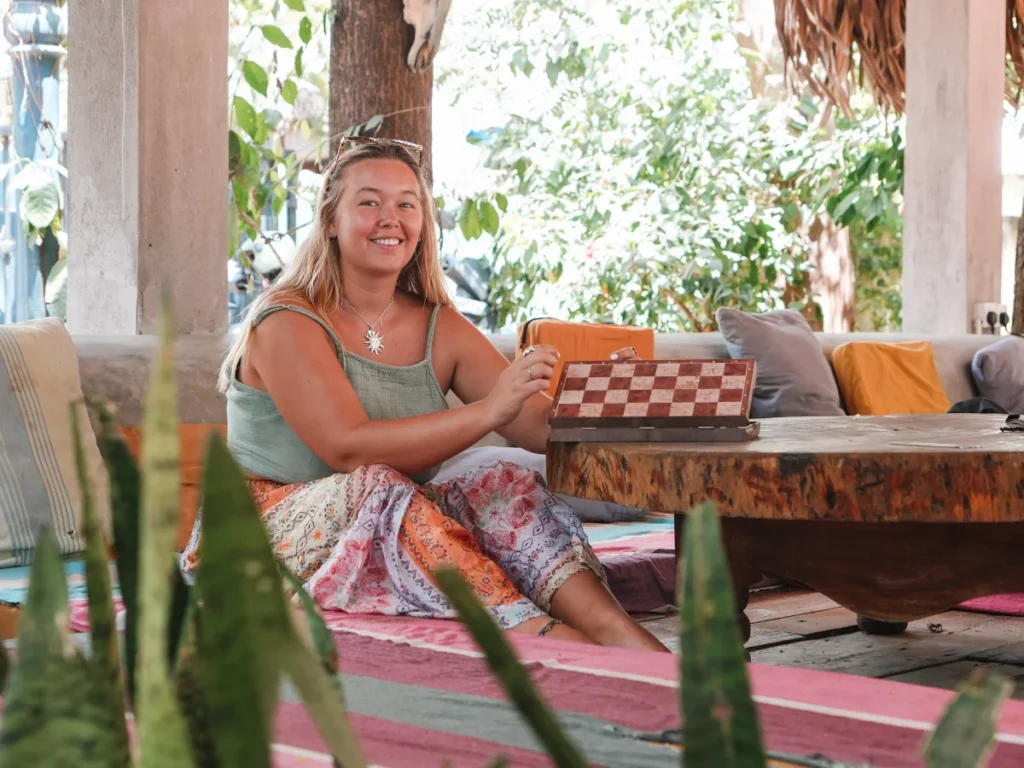 A girl plays chess in the outdoor seating area at Waypoint